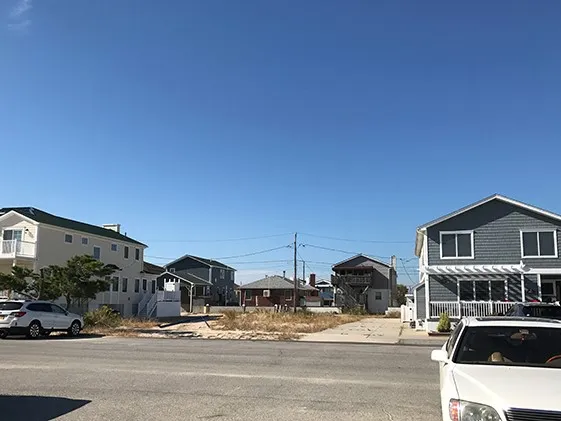 A vacant lot where a home likely stood before Hurricane Sandy struck this neighborhood in Breezy Point, Queens. Some residents chose to take government buyouts, while others chose to rebuild. Photo: Sarah Fecht